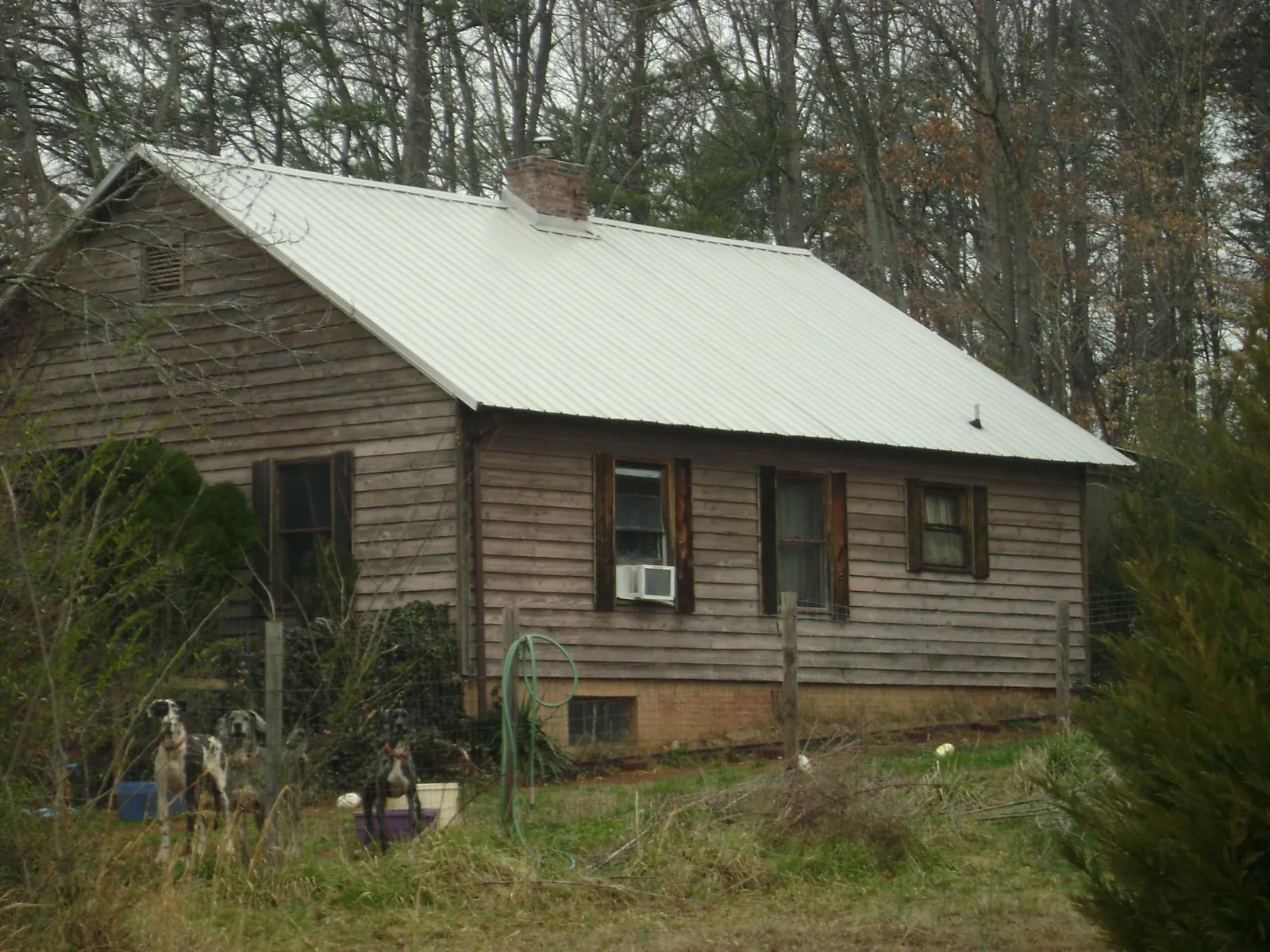 White metal roof on an old wood sided farmhouse, from a Metal Roof Installation job in Stony Brook
